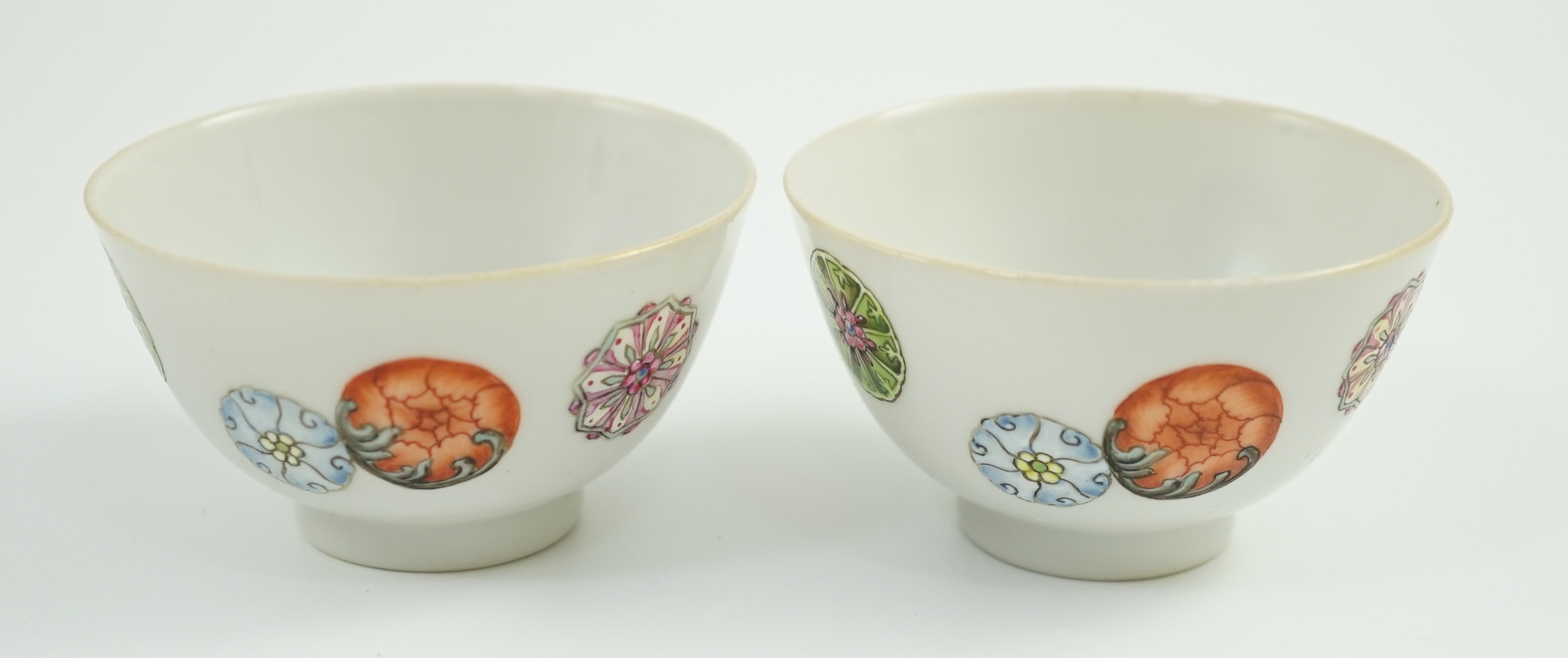 A pair of Chinese enamelled porcelain tea bowls, Qianlong seal marks, 7cms diameter